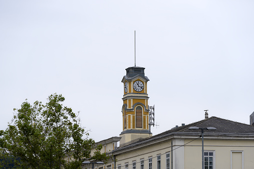 Clock tower of main railway station at Slovenian City of Ljubljana with clock tower on a cloudy summer day. Photo taken August 9th, 2023, Ljubljana, Slovenia.