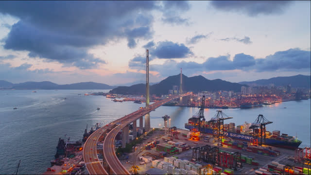Aerial view of sunset View of Coastal City with Bridge and Port, 
Hong Kong, Asia.