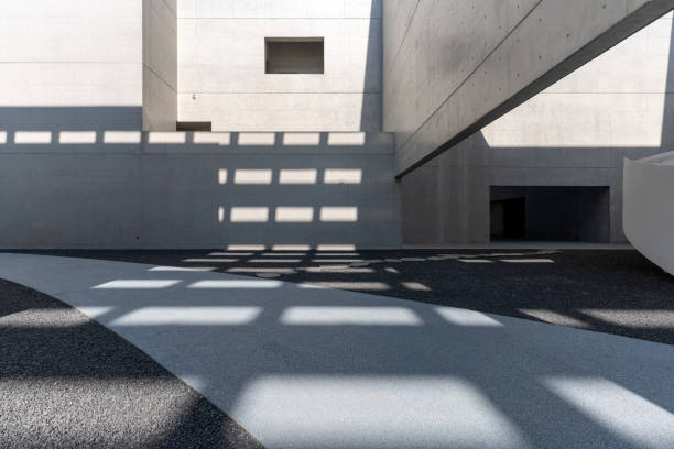 istock Sunshine leaves light and shadow on cement walls and structures in modern architecture 2059999955