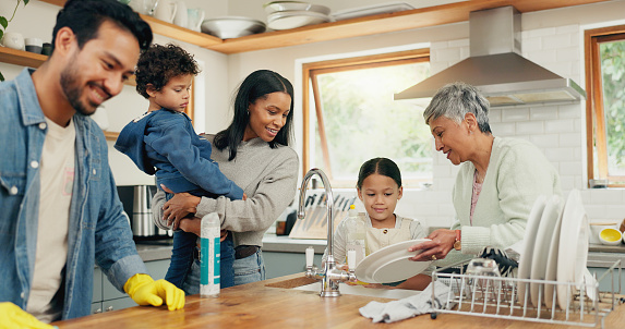 Cleaning, family and man in a kitchen with cloth for table, hygiene or clean living space after dinner. Washing, dishes and guy parent with household chore for safety from bacteria, dirt or germs