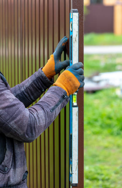 istock Workers install a metal profile fence 2060005279