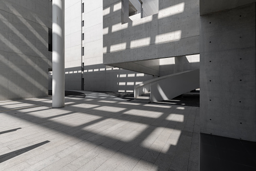 Sunshine leaves light and shadow on cement walls and structures in modern architecture