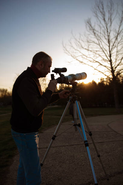 istock Amateur astronomer observing Sun eclipse and Sun with a telescope and special solar filter. 2060019102