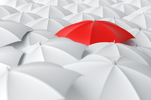 Red umbrella standing out from the crowd of white umbrellas. Individuality, difference, leadership and struggle concepts. Top view. 3D rendering.