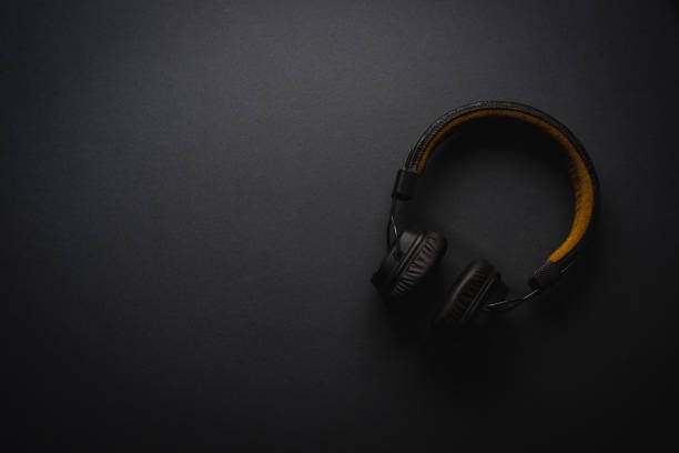 istock Retro style wireless over-ear headphones on dark gray background 2060026113