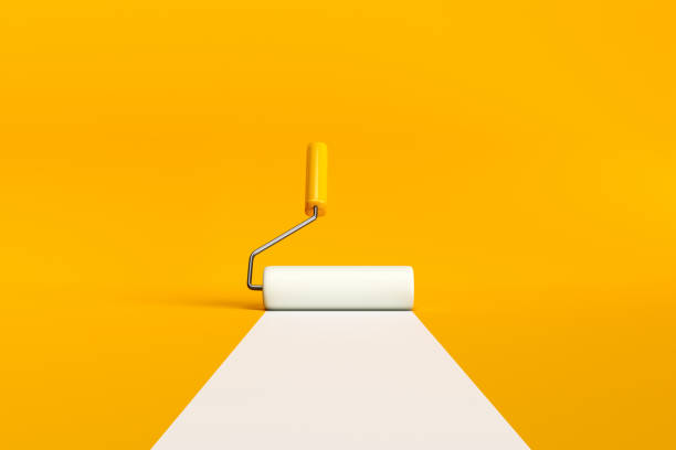 istock Paint roller brush painting a white line on yellow background. 2060026677