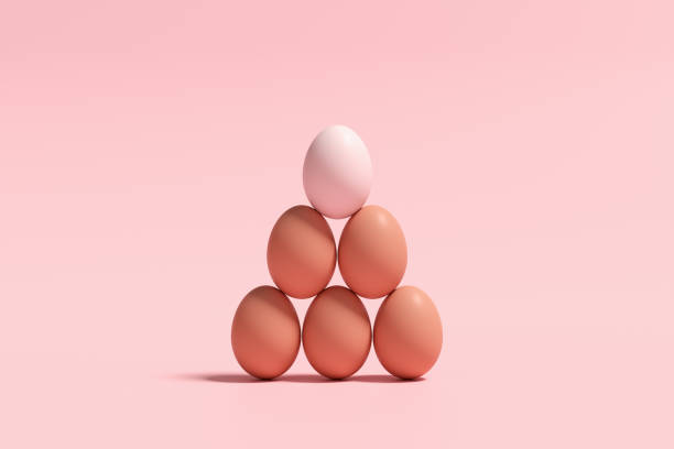 istock Pyramid of eggs against pink background. 2060029453
