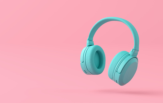 Monochromatic blue wireless headphone on pink background with copy space. 3D rendering.