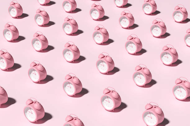 istock Repetitive pink alarm clocks on pink background. 2060031092