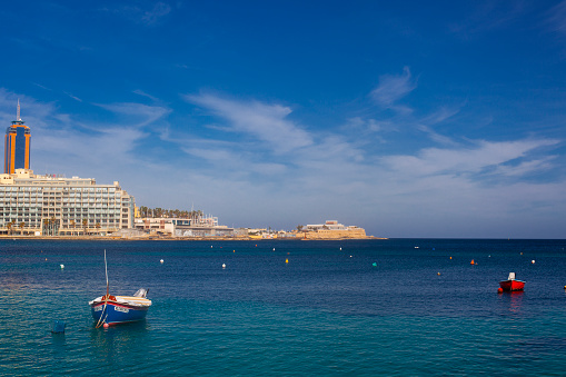 Malta - 9 Feruary, 2024: Saint Julian Bay with traditional colourful fishing Boats Luzzu, Malta