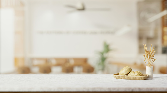 A white marble table features a bread basket, dried pampas grass in a ceramic vase, and a copy space with a blurred background of a minimally cozy coffee shop. 3d render, 3d illustration