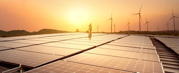 Installing solar panels and wind farms - wind-powered electrical generators, new technology for Renewable energy clean and good environmentally. panoramic banner. Installing solar panels and wind farms on the mountain- wind-powered electrical generators, new technology for Renewable energy clean and good environmentally. panoramic banner. windmill sunset stock pictures, royalty-free photos & images