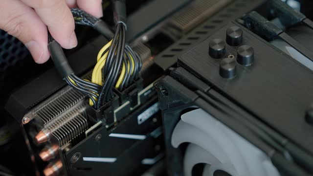 Man's Hands Plug in a VGA card to motherboard