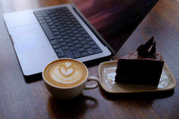 hot mocha with chocolate cake and laptop on the table