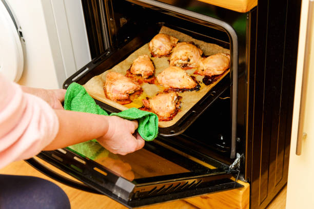 istock womans hands pull up Fried chicken meat from the oven. Poor dinner,view from above. Close-up. Selective focus. 2060078232