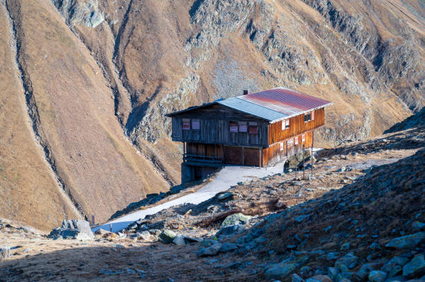 Wooden cottage high in stone mountains.