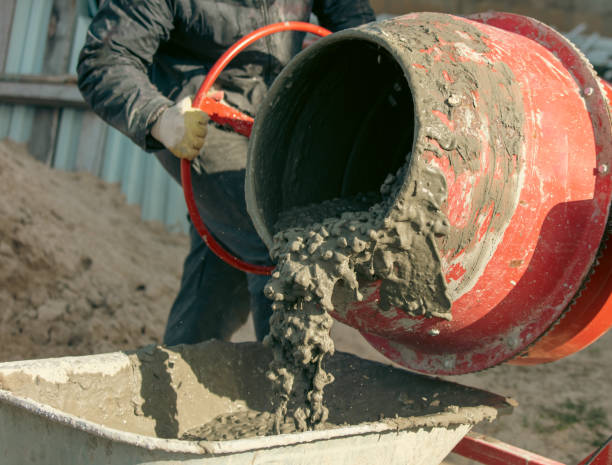 istock Worker pouring concrete with cement mixer at construction site, closeup 2060084327