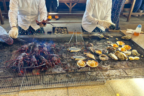 charcoal-grilled fresh spiny lobster, shellfish and fish by ama divers at ama diver hut.  mie prefecture, japan - asia cooked food gourmet imagens e fotografias de stock