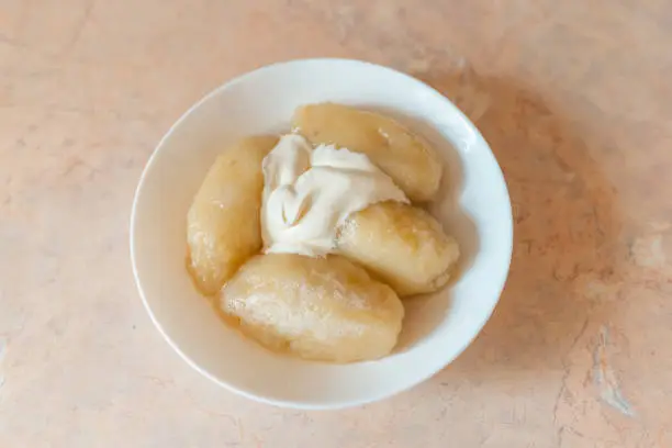 Photo of Traditional Lithuanian dish meal cuisine, stuffed meat potato dumpling,most popular Lithuanian national dish on a plate.