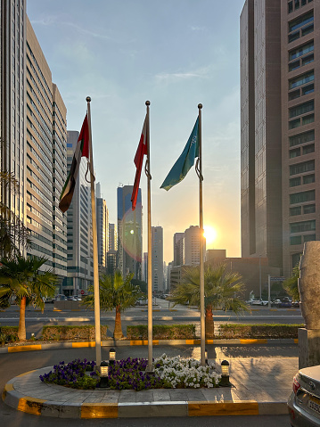 Abu Dhabi, United Arab Emirates, March 31, 2018: View of the iconic skyscrapers including Etihad Towers with the flag of the United Arab Emirates.