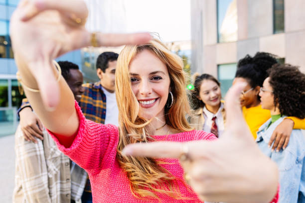 istock Pretty woman smile at camera making frame with fingers 2060115679