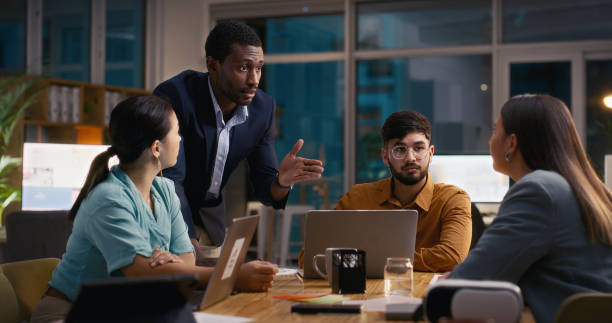 istock Team, night meeting and people with discussion at startup, web design project and collaboration for SEO deadline. Diversity, partnership for ideas and website development with tech at creative agency 2060115688