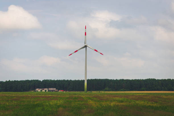 Single windmill generating electricity against blue sky.Beautiful wind turbine on blue sky and white clouds background. eco friendly electric power source.