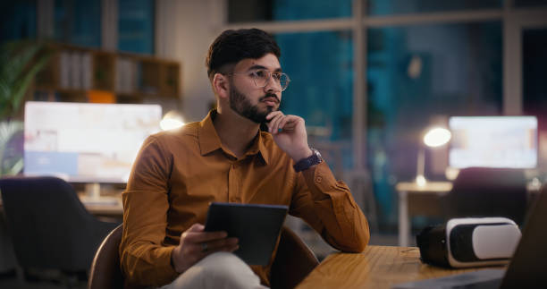 istock Businessman, thinking or tablet for developer at work, gaming or professional career in technology. Indian entrepreneur, plan or touchscreen for online research, vr or connection in start up company 2060133131