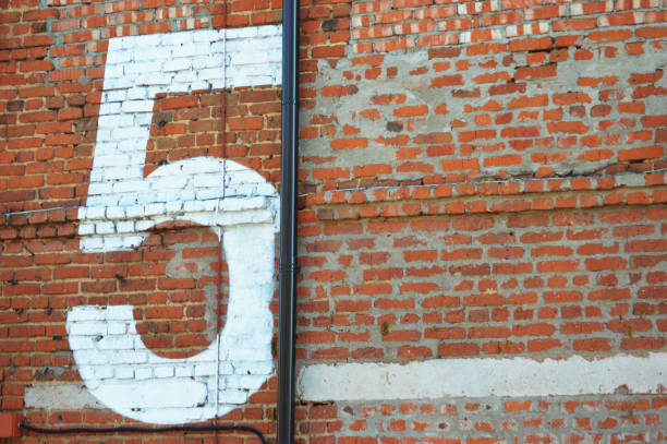 istock White number five painted on a red brick wall. Number 5. 2060134764