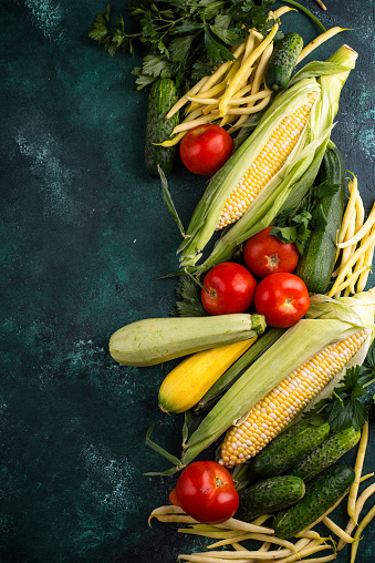 Assortment of various vegetables. Summer harvest. Healthy vegan food on green background