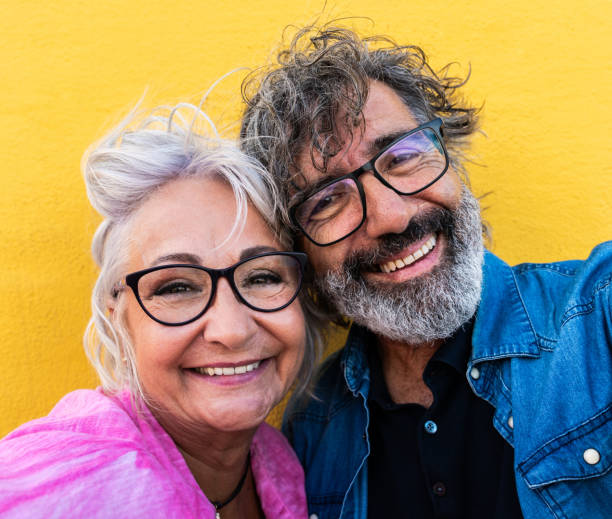 Beautiful happy senior couple bonding outdoors Beautiful happy senior couple bonding outdoors - Cheerful old people romantic dating in the city, concepts about elderly and lifestyle multi coloured glasses stock pictures, royalty-free photos & images
