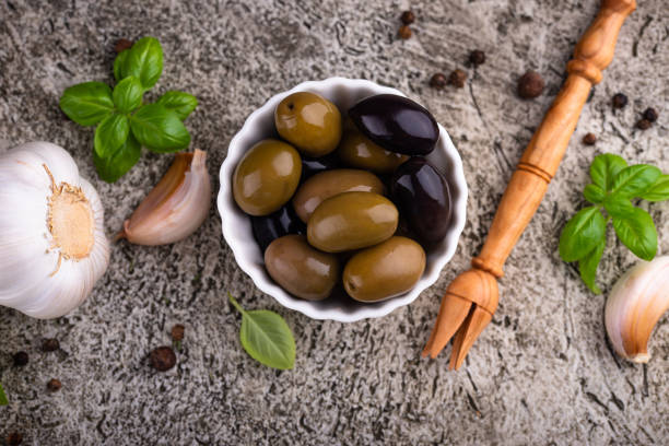 Bowl with Greek green and black spicy pickled olives