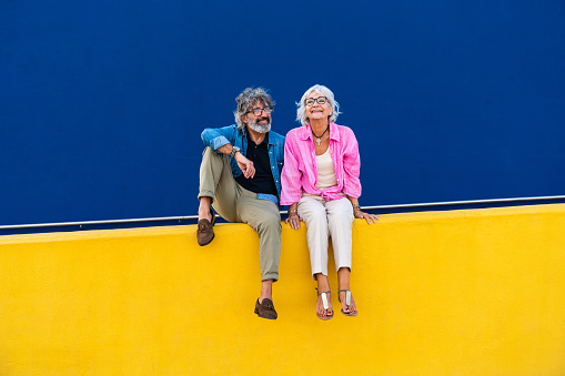 Beautiful happy senior couple bonding outdoors - Cheerful old people romantic dating in the city, concepts about elderly and lifestyle