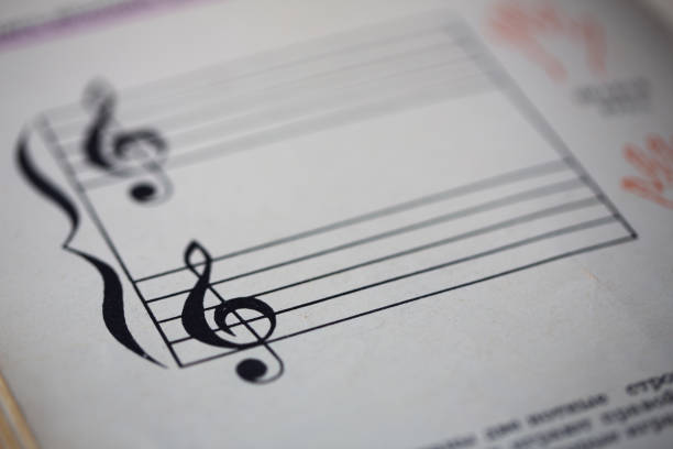 A page from a book with musical notes as a background, close-up view
