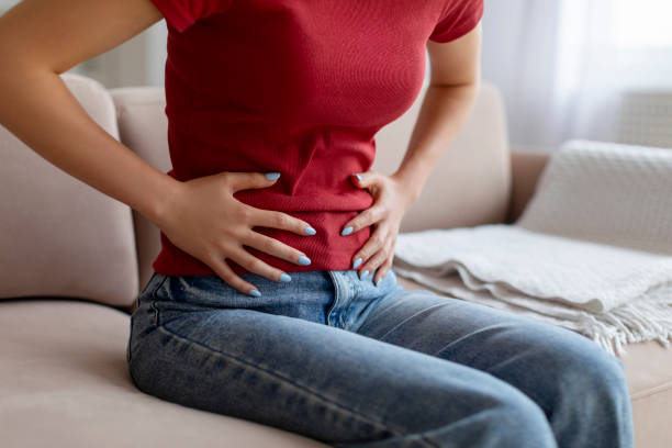 istock Unrecognizable woman experiencing abdominal pain at home 2060153299