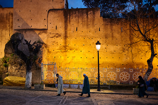 Place Outa El Hamam square and Kasbah wall at night in Chefchaouen, Morocco, North Africa.