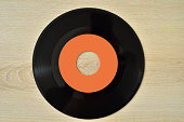 45 rpm old vinyl record on the wooden table