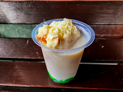 Durian Cendol Ice Drink in plastic glass packaging which is suitable for breaking the fast menu. This photo is suitable for something with a drink and culinary theme