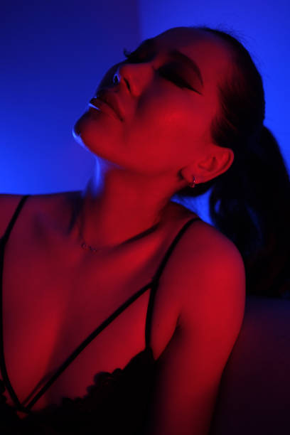 istock Seductive Young Woman in Colorful Neon Lights 2060192612