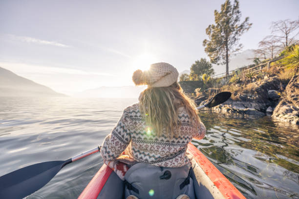 istock Woman in red inflatable canoe on calm lake 2060200657