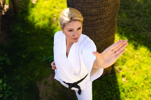 Adult black belt woman demonstrating karate moves