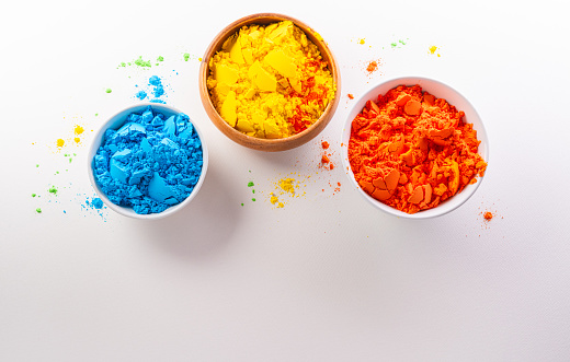 Happy Holi decoration, the indian festival.Top view of colorful holi powder on white background.