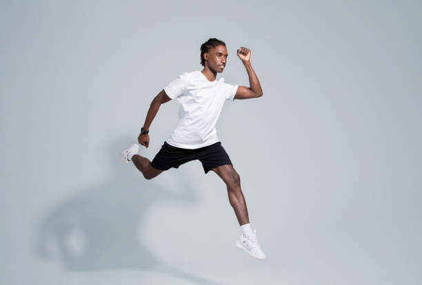 istock Dynamic black man in sportswear running on grey studio background 2060222478
