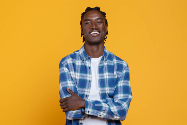 istock Handsome Young Black Man Posing With Folded Arms On Yellow Studio Background 2060223037