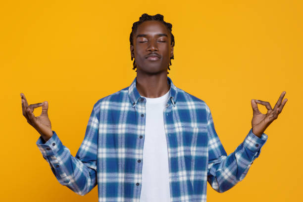 istock Young black man meditating in zen pose with serene face expression 2060223041