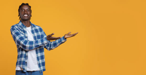 istock Look There. Happy Young Black Guy Pointing Aside At Copy Space 2060223074