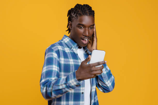 istock Mobile Offer. Surprised black guy looking at smartphone screen with excitement 2060223079