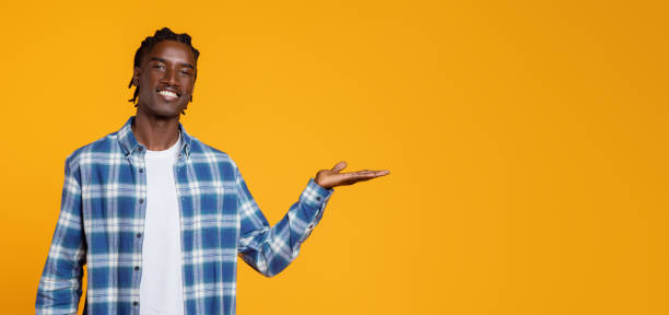 istock Happy Black Man Showing Invisible Object On Open Palm 2060223631