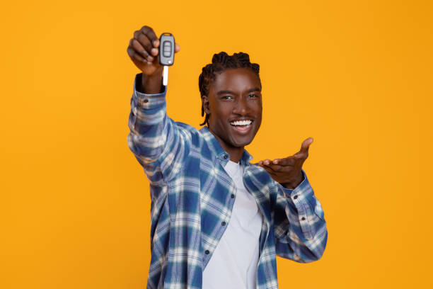 istock Ecstatic young black man presenting car keys with an outstretched hand 2060223641