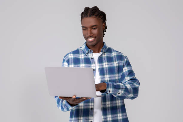 istock Happy Young Black Man With Laptop In Hands Posing Over Grey Background 2060223652